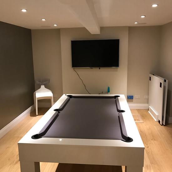 A converted basement with a pool table